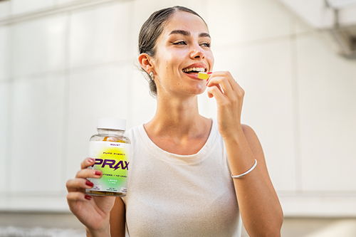 happy woman taking a paraxanthine gummy